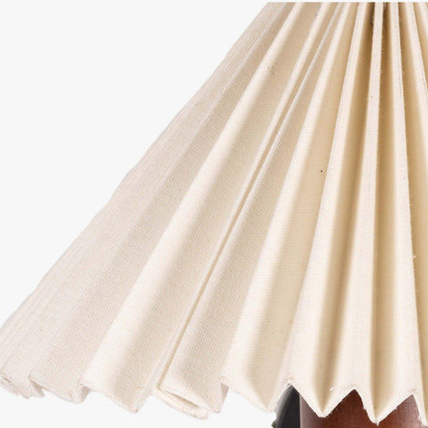White pleated shade wall lamp with a natural wooden cylindrical base in walnut finish, perfect as a bedside wall lamp or decorative wall sconce for minimalist and vintage interiors.