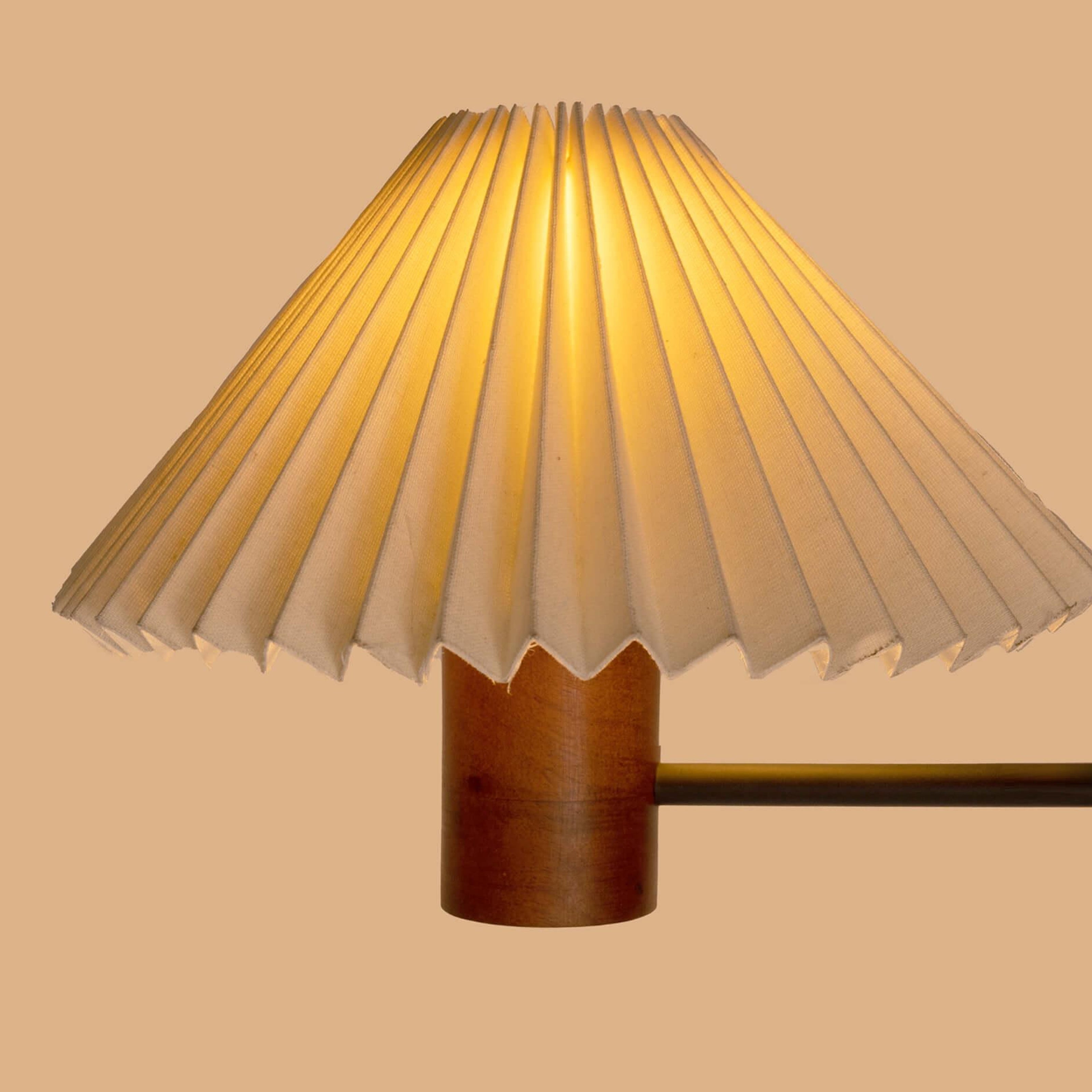 White pleated shade wall lamp with a natural wooden cylindrical base in walnut finish, perfect as a bedside wall lamp or decorative wall sconce for minimalist and vintage interiors.