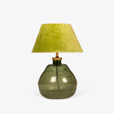 Close-up detail of the green fabric lampshade and brass neck hardware.