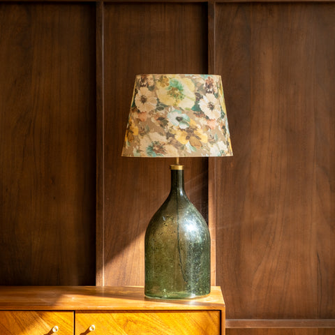 Studio shot of the green glass bottle lamp on a white background.