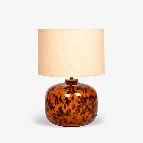 Studio shot of the tortoiseshell glass table lamp on a white background.