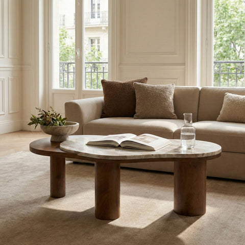 Modern marble-top coffee table styled with book and decor in a cozy living room.