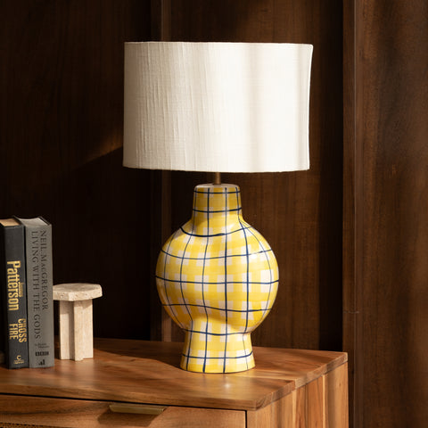 ellow plaid lamp on a console table in a stylish living room.