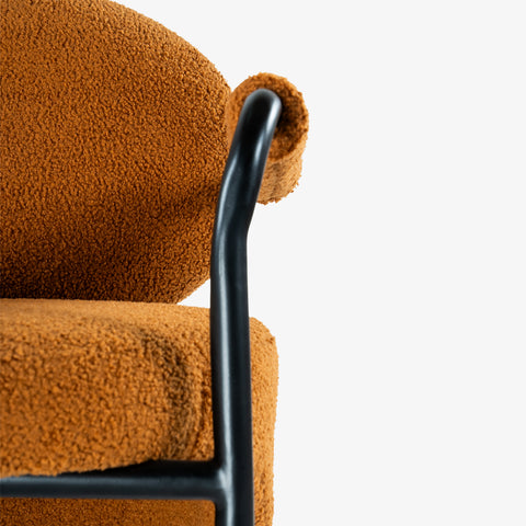 Close-up of chair armrest and textured upholstery