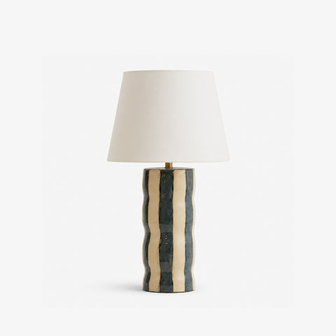 Studio shot of the small striped ceramic table lamp on a white background.