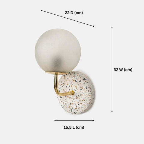 Eros White Wall Lamp with Terrazzo base, Gold-finished Mild Steel, and Frosted Glass shade.  This lamp is available online in India.
