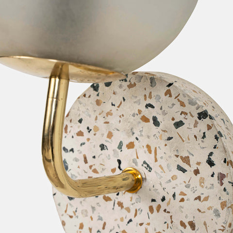 Eros White Wall Lamp with Terrazzo base, Gold-finished Mild Steel, and Frosted Glass shade.  This lamp is available online in India.