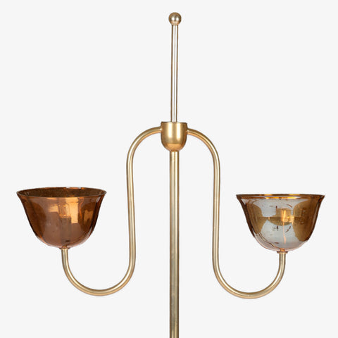 Close-up of brass lamp arms and amber shades.