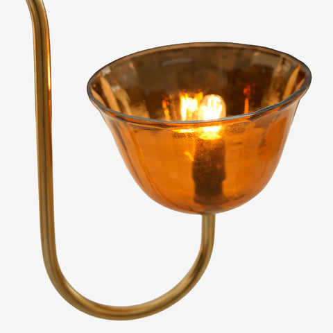 Close-up of a lit amber glass lamp shade.