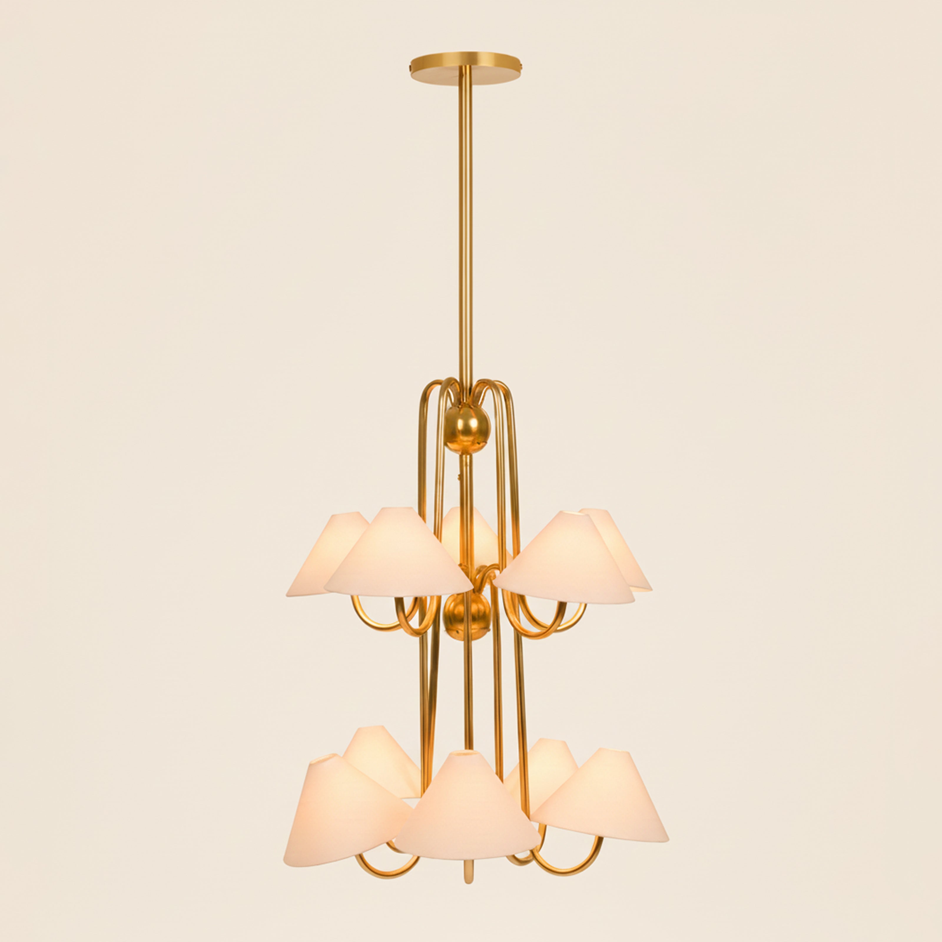 Modern brass chandelier with linen shades, warm ambient ceiling light for living room.