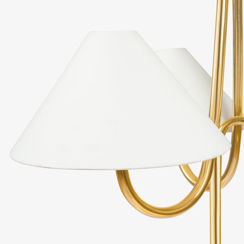 Conical white lampshade with brass arm, modern chandelier detail.