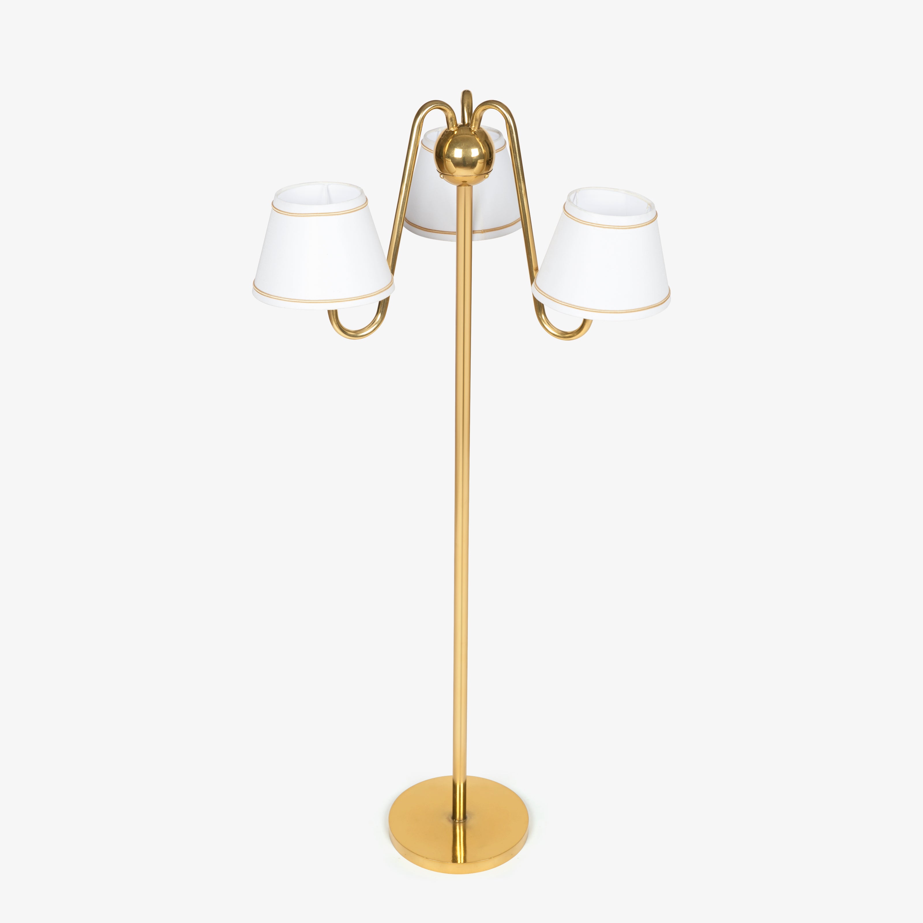 Three-arm floor lamps India design with a brass-finish pole and white shades, a decorative choice for bedroom lamps.