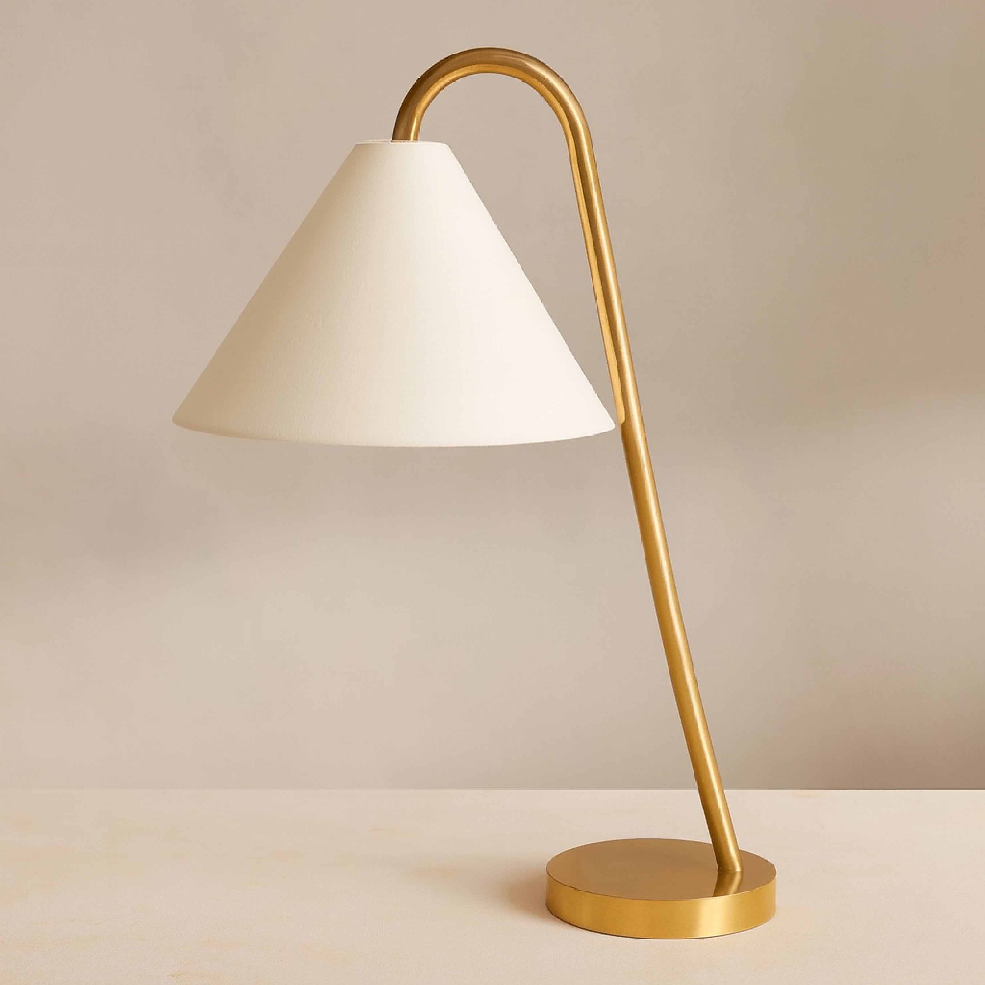 Modern brass table lamp with curved arm and fabric shade for living room