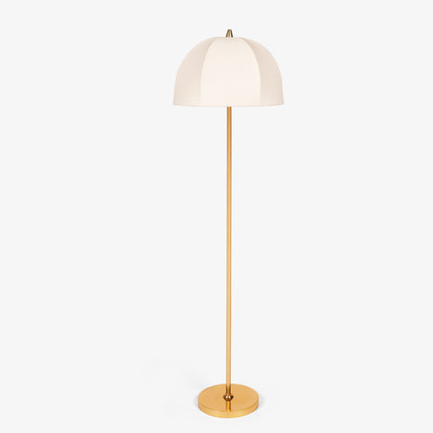 Brass floor lamp with slim metal stem and dome-shaped fabric shade on round base.