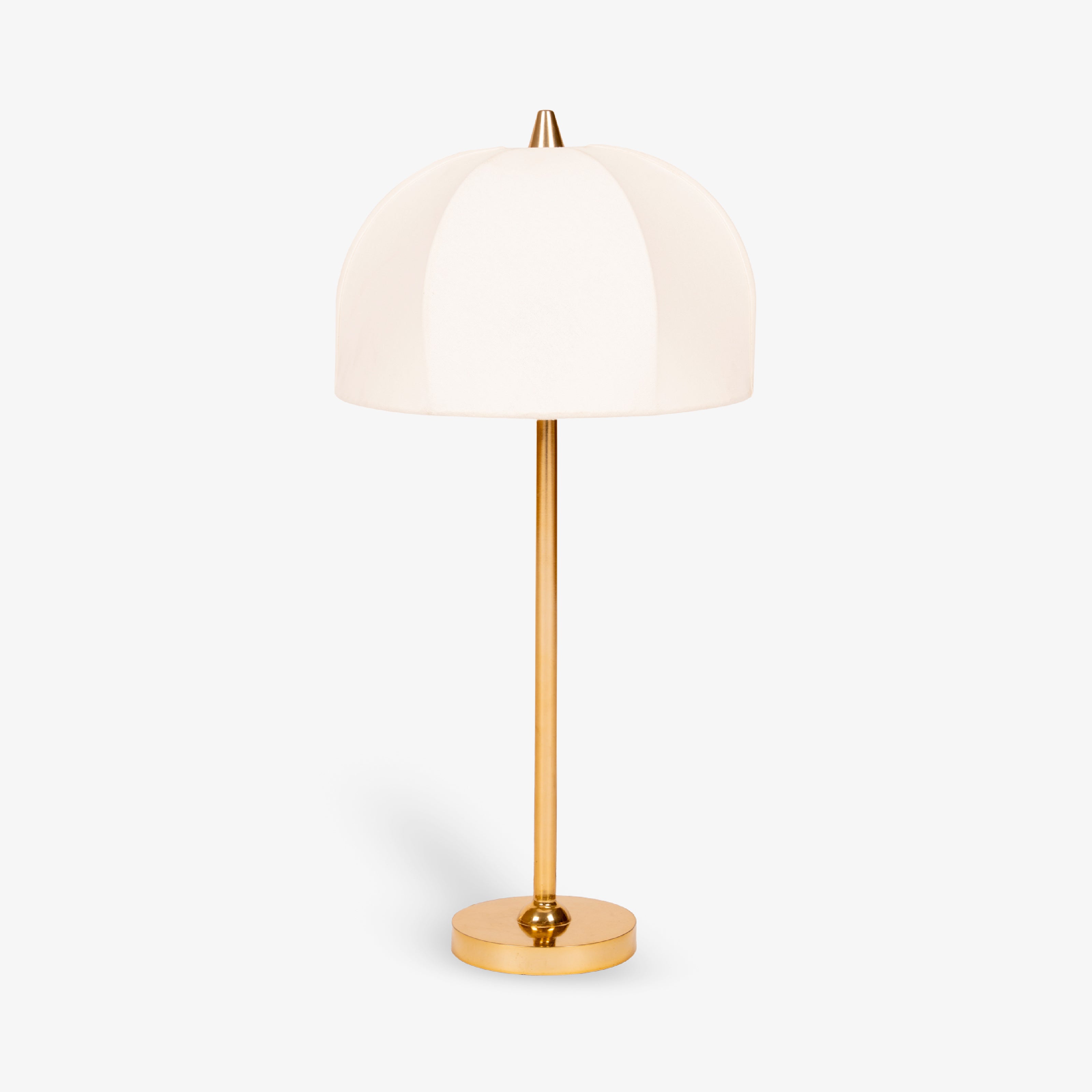 Modern brass table lamp with white fabric shade on white background