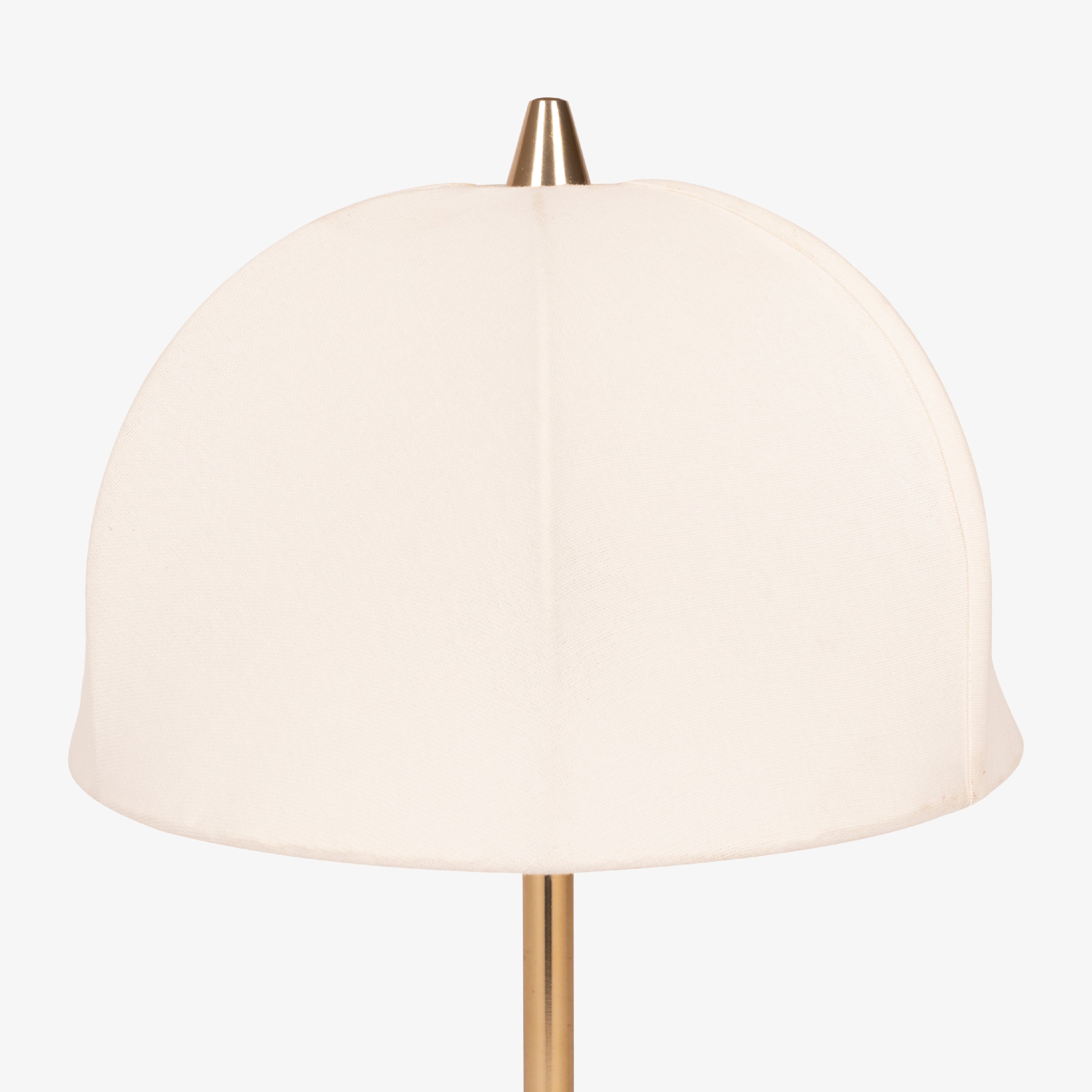 Close-up of fabric dome shade on brass table lamp