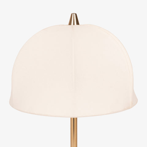 Close-up of fabric dome shade on brass table lamp