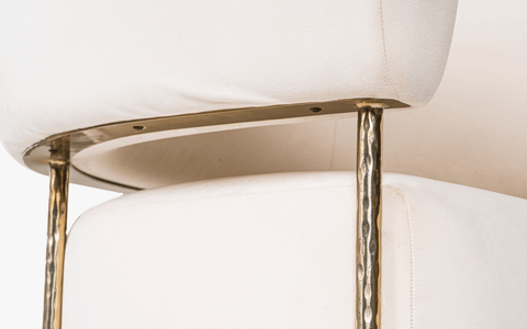 Buda Lounge Chair with modern design, plush upholstery, and hammered texture brass finish on stainless steel legs. Perfect lounge chair for bedroom.
