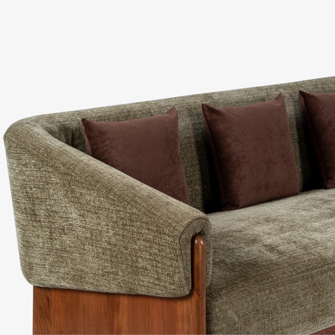 Close-up of wooden sofa arm with brown cushions