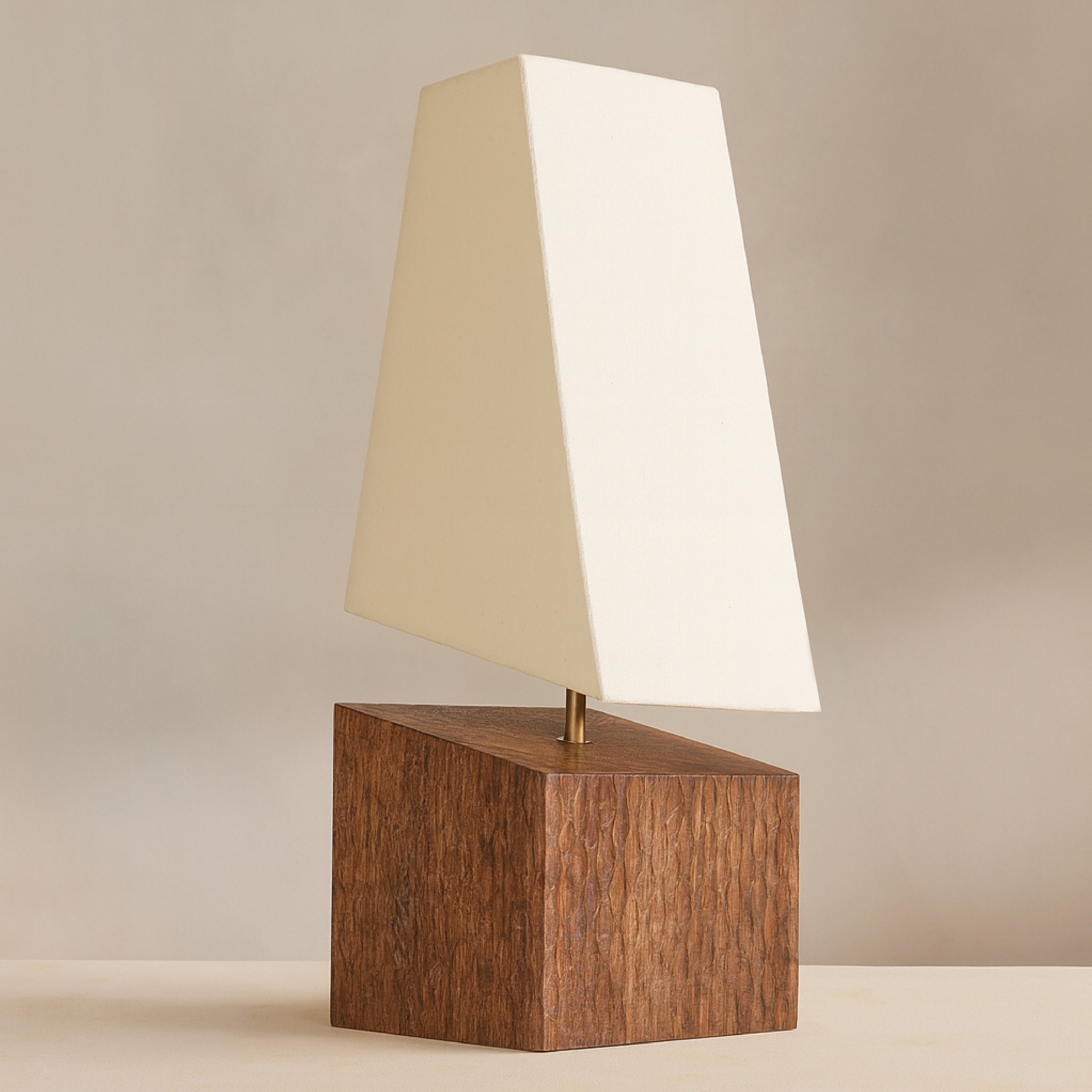 Wooden table lamp with angled fabric shade styled in a modern living room