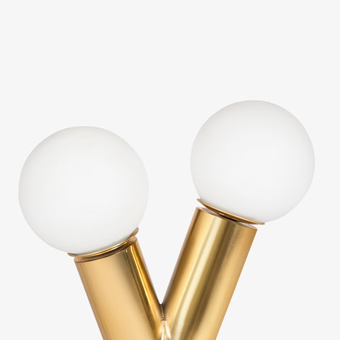 A focused shot of the two white frosted globe bulbs attached to the polished brass-finish sockets.