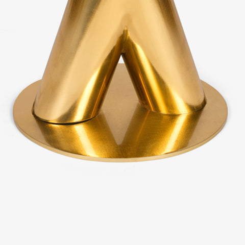 A close-up detail of the circular gold metal base plate where the two angled pillars are mounted.