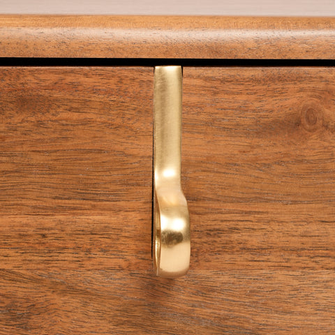 Brass handle detail on wooden drawer