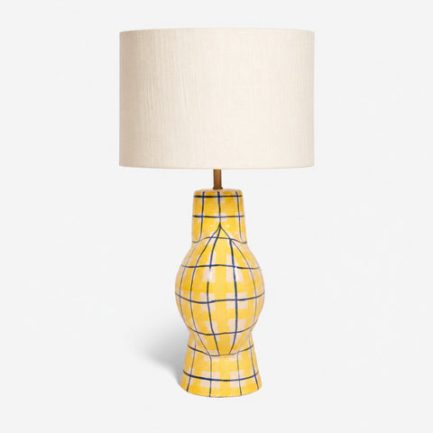 Studio shot of the yellow plaid table lamp on a white background.