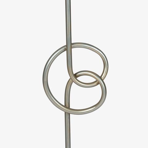 Close-up of geometric metal ring base of floor lamp
