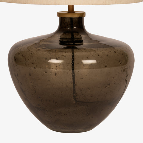 Close-up profile of the rounded smoky glass lamp base.