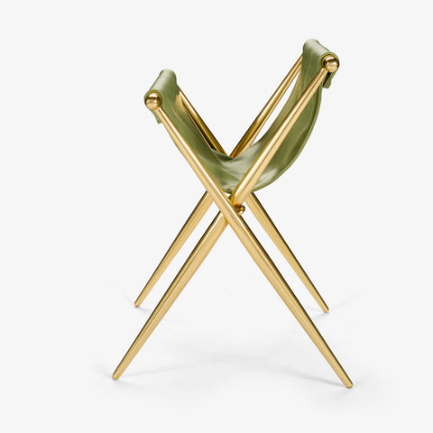 Folded brass stool showing X-frame