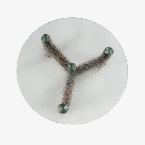 A bird's-eye view of the coffee table showing the three legs supporting the circular glass top.
