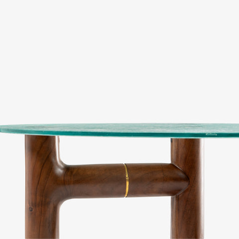 A side profile detail showing the gold metal inlay on the dark wood table leg.