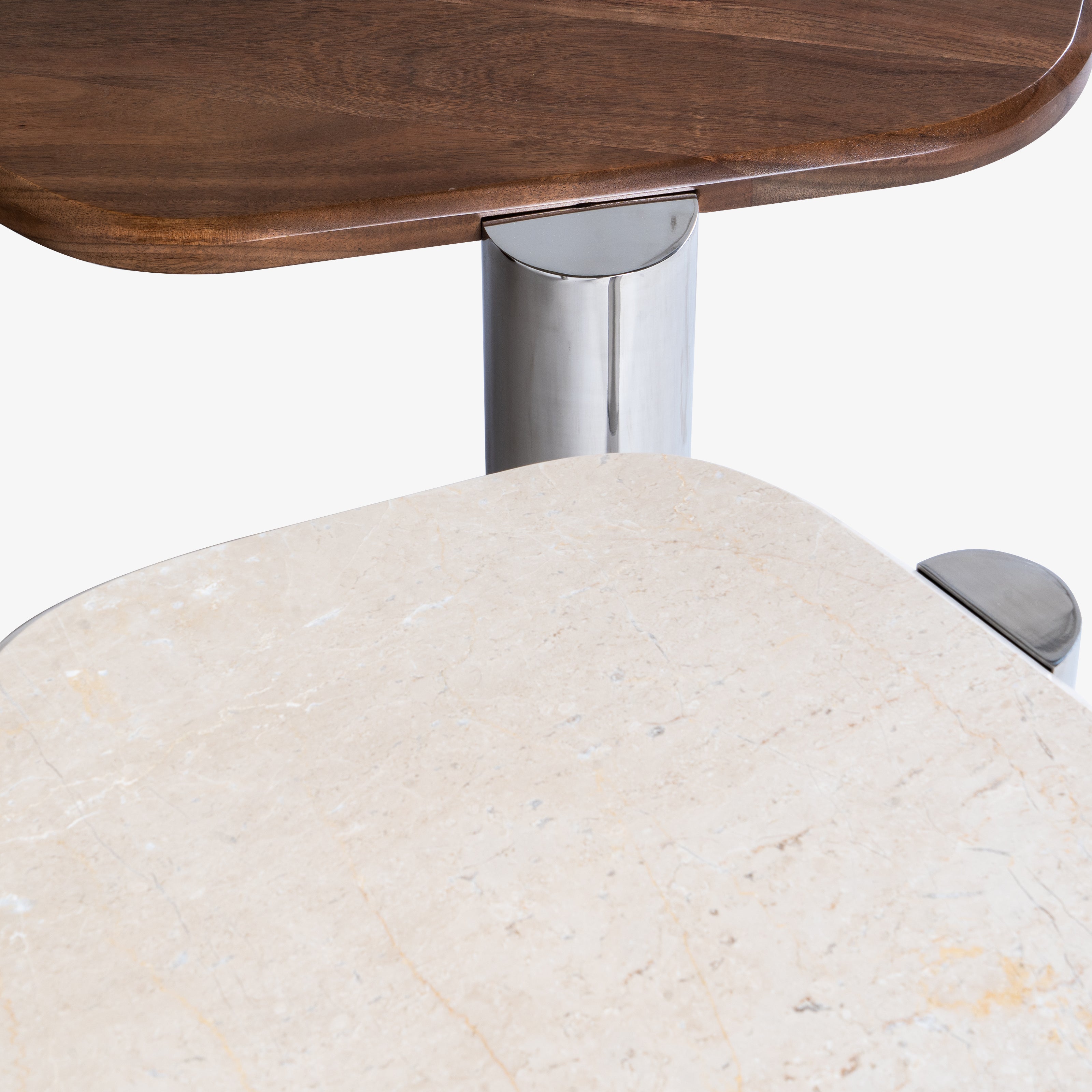 Close-up of wooden tabletop with chrome leg.