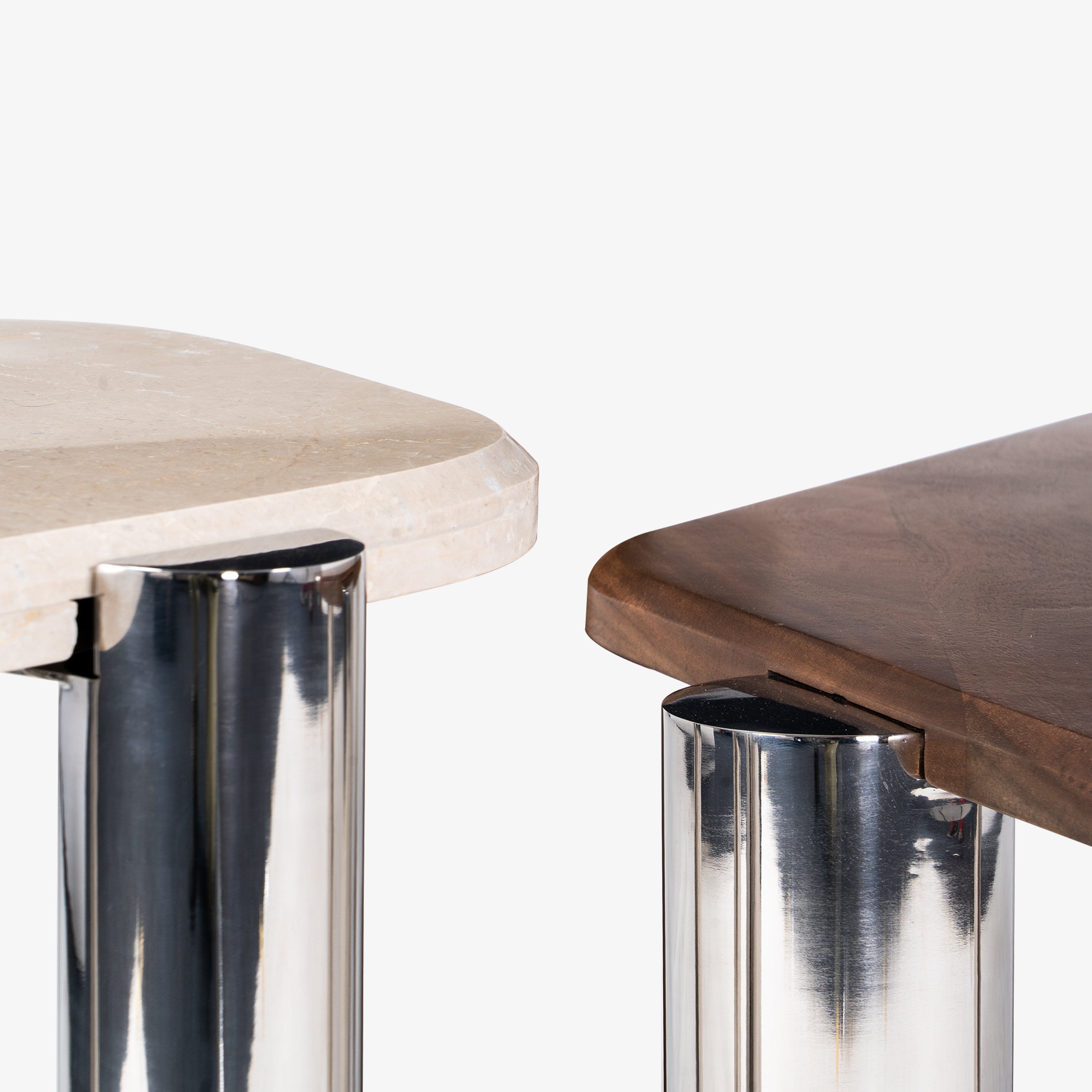 Close-up of chrome legs supporting nesting table tops.
