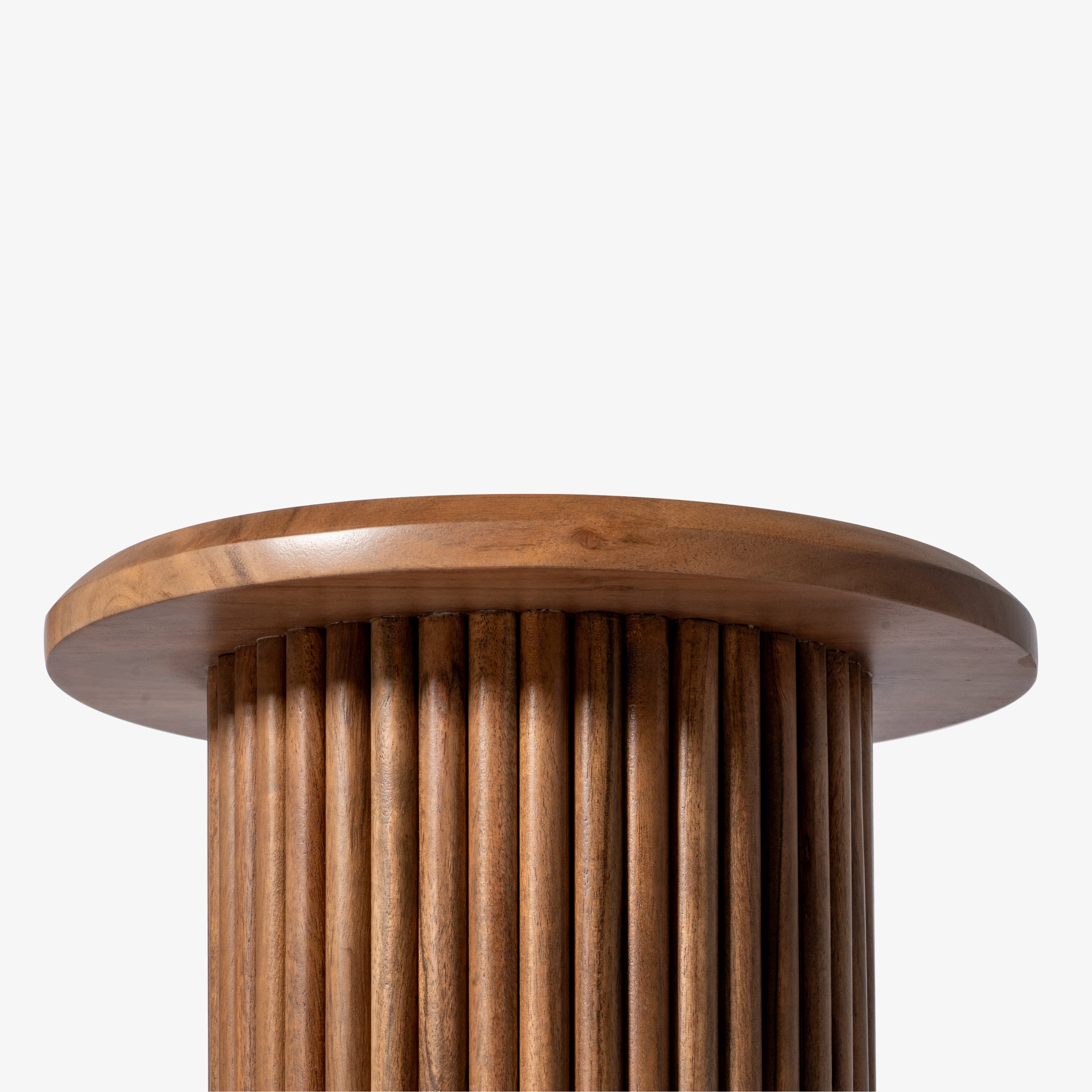 Close-up of the vertical fluted base of a wooden side table.