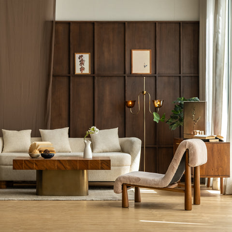 Modern living room with a brass floor lamp and wood walls.