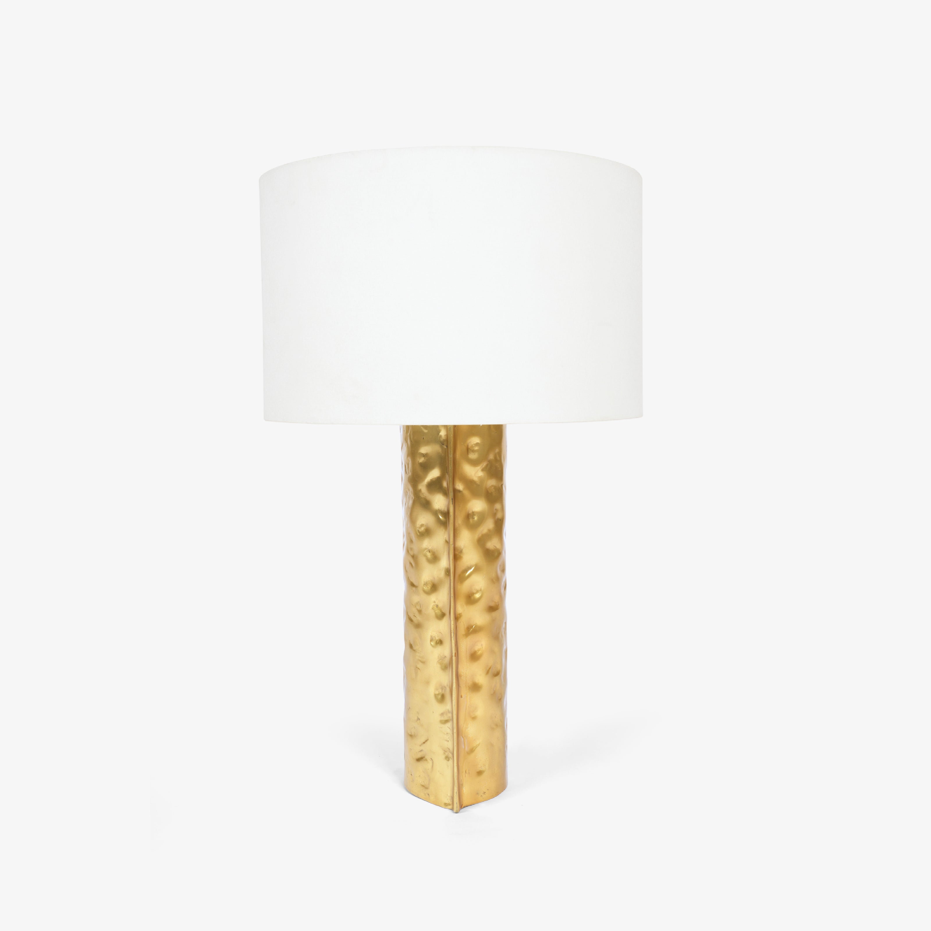 Side profile of a gold bedside lamps structure with a single glowing globe.