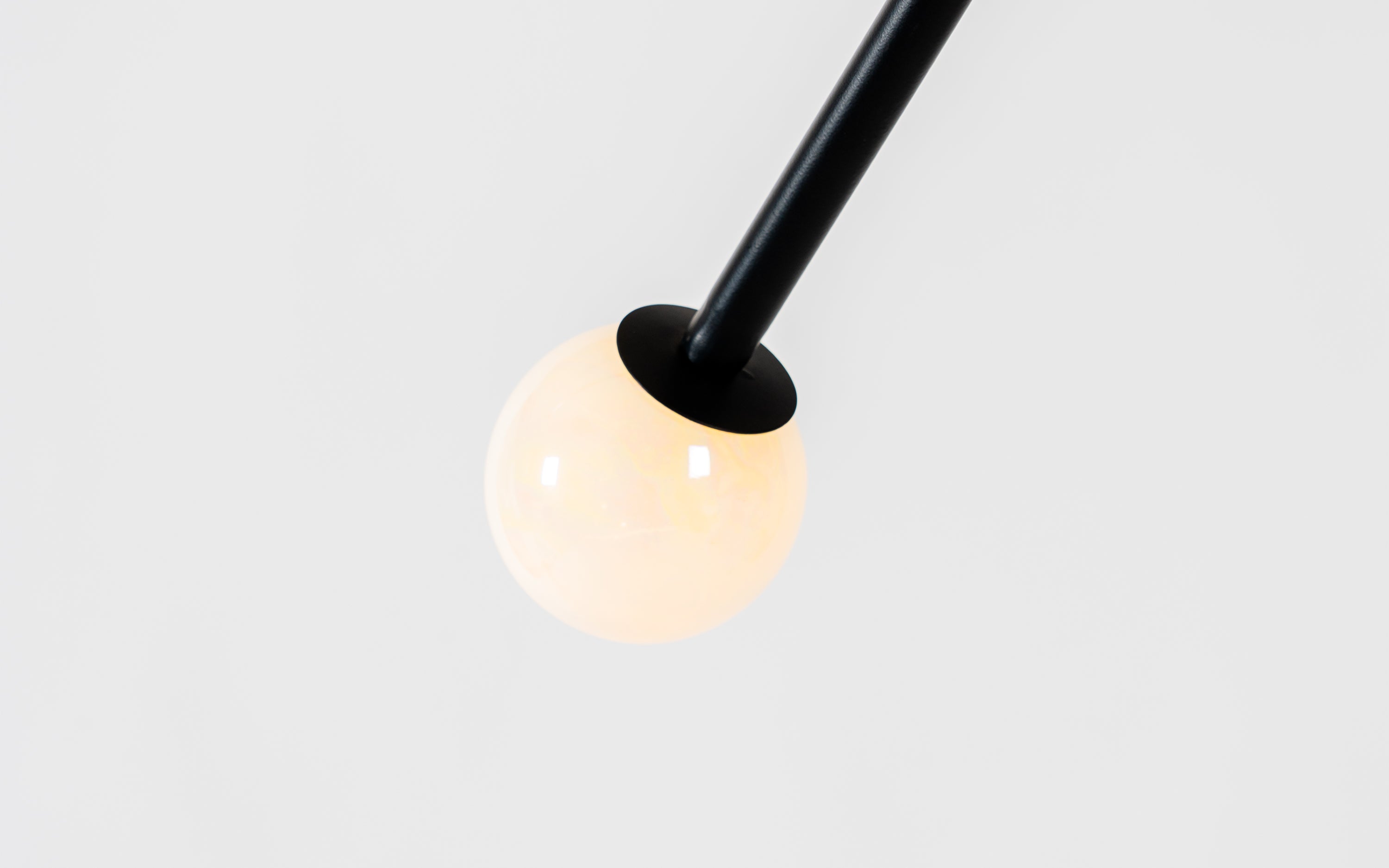 Niora Hanging Lamp | Dual Opal Glass Globe & Black Metal Frame - Close shot - from upper angle - Orange Tree