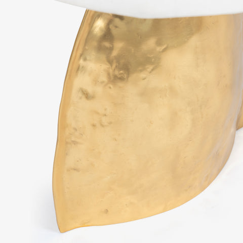 Close-up of hammered gold metal base of a designer table lamp for home decor.