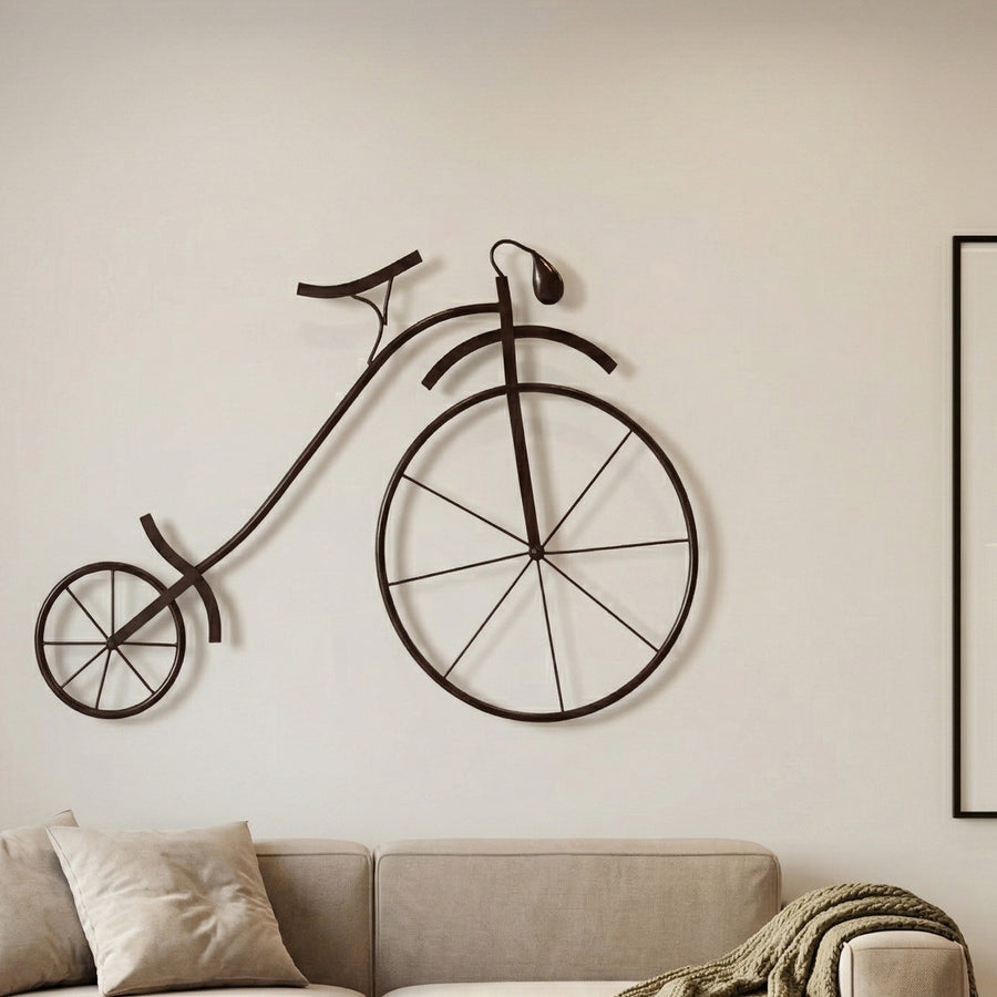 Metal wall decor with vintage cycle design and antique gold finish.