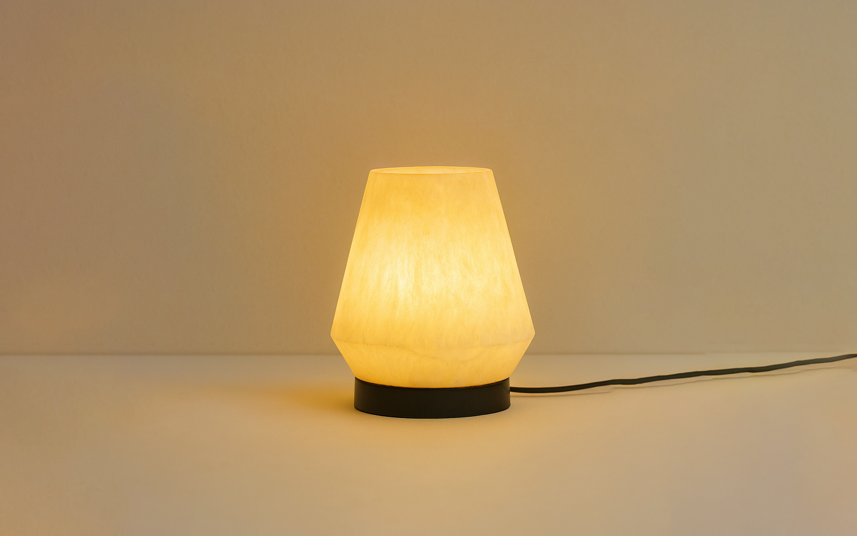 Orira Small Round Table Lamp | Marble Resin with Black Base - Close shot - from upper angle - Orange Tree