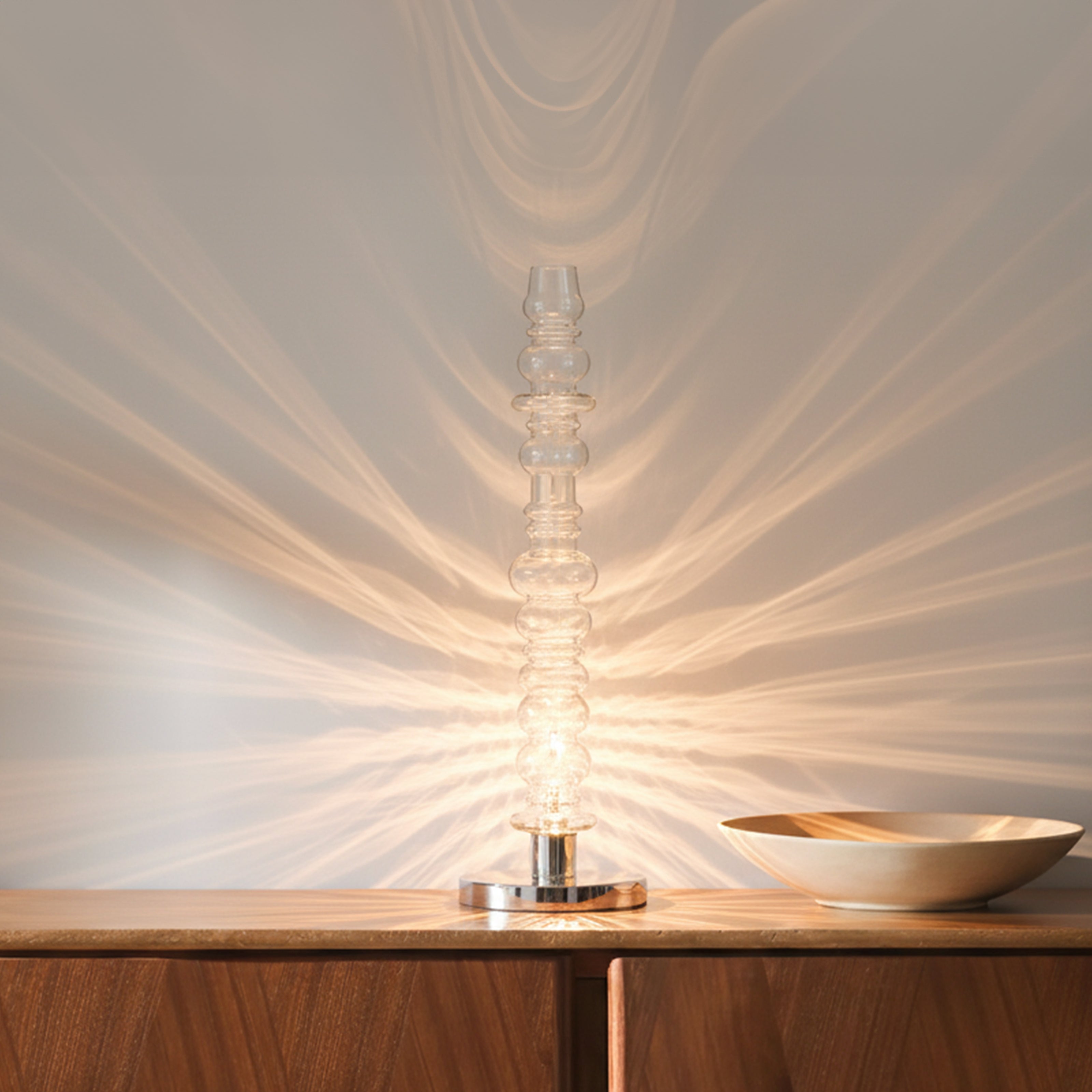 Clear glass table lamp creating artistic light patterns, modern home decor lighting