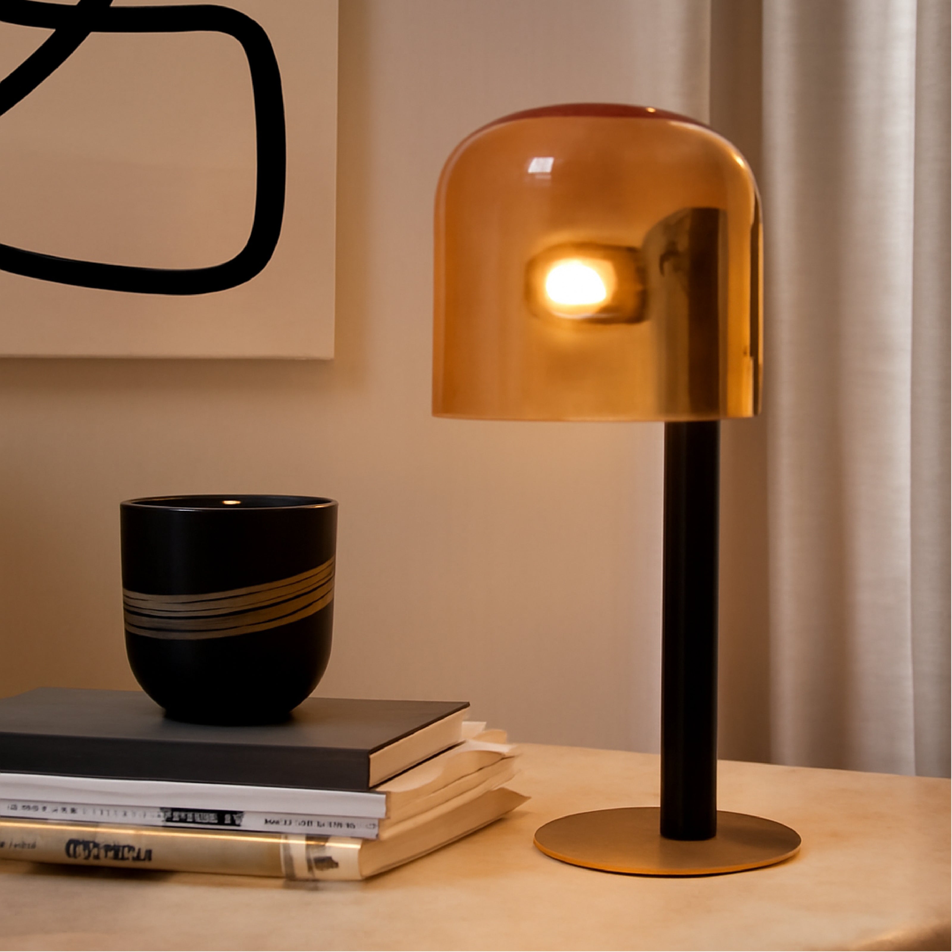 An amber glass study table lamp styled on a desk, perfect as side lamps for living room.