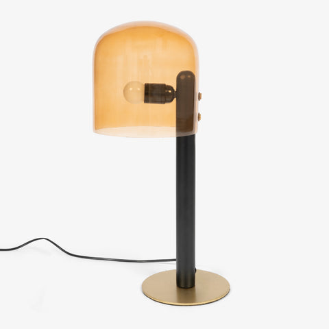 A night lamp for bedroom with a warm amber glow and minimalist black support.
