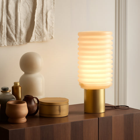 A glowing ribbed night lamp for bedroom with a gold base, styled as home decor lamps.