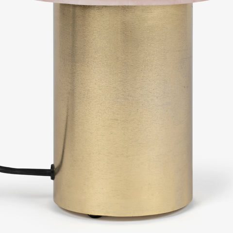 Solid gold cylindrical base for a minimalist and elegant bed lamp.