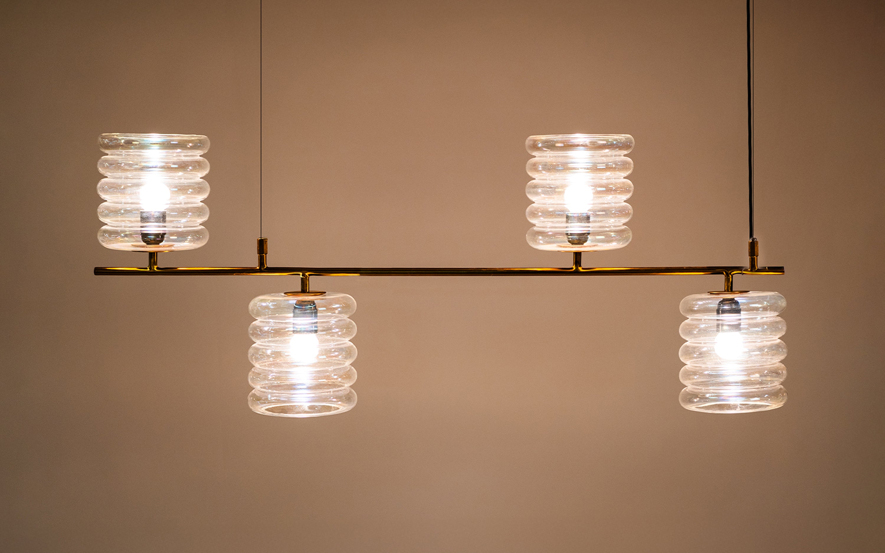 Buy Unio Linear Glass Chandelier Lamp of 4 | Brass Metal Frame - with white background - Orange Tree
