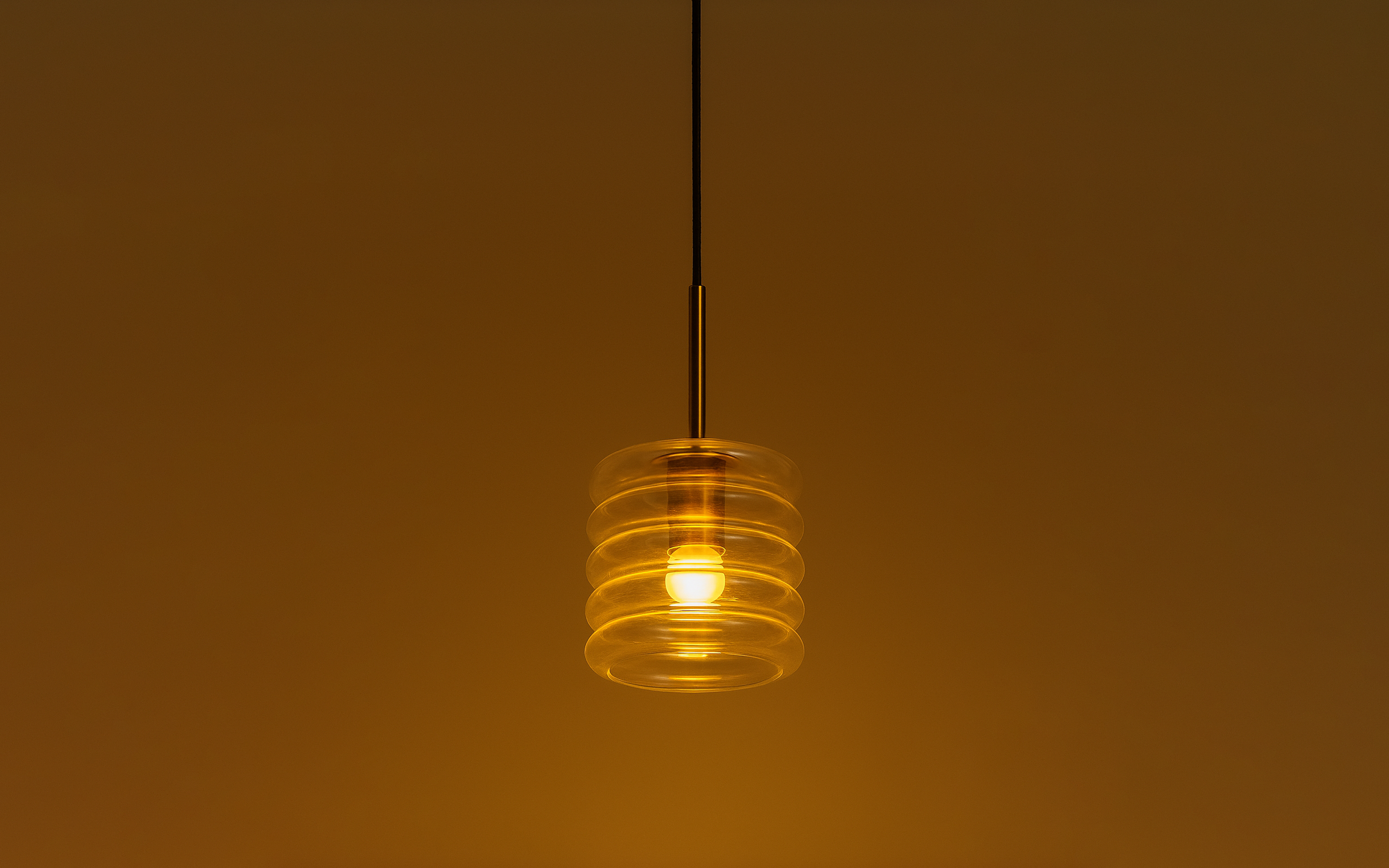 Buy Unio Cylindrical Glass Hanging Lamp | Brass Finished Metal - Close shot - from upper angle - Orange Tree