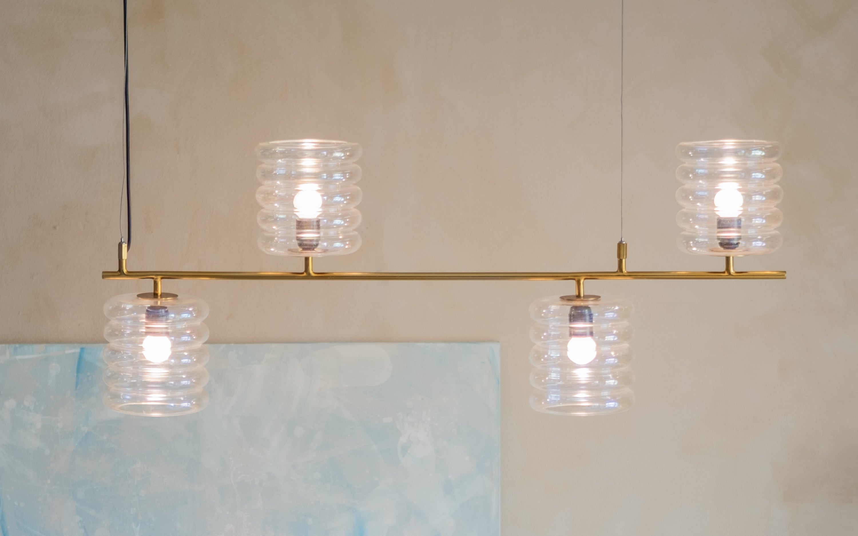 Buy Unio Linear Glass Chandelier Lamp of 4 | Brass Metal Frame - Close shot - Orange Tree